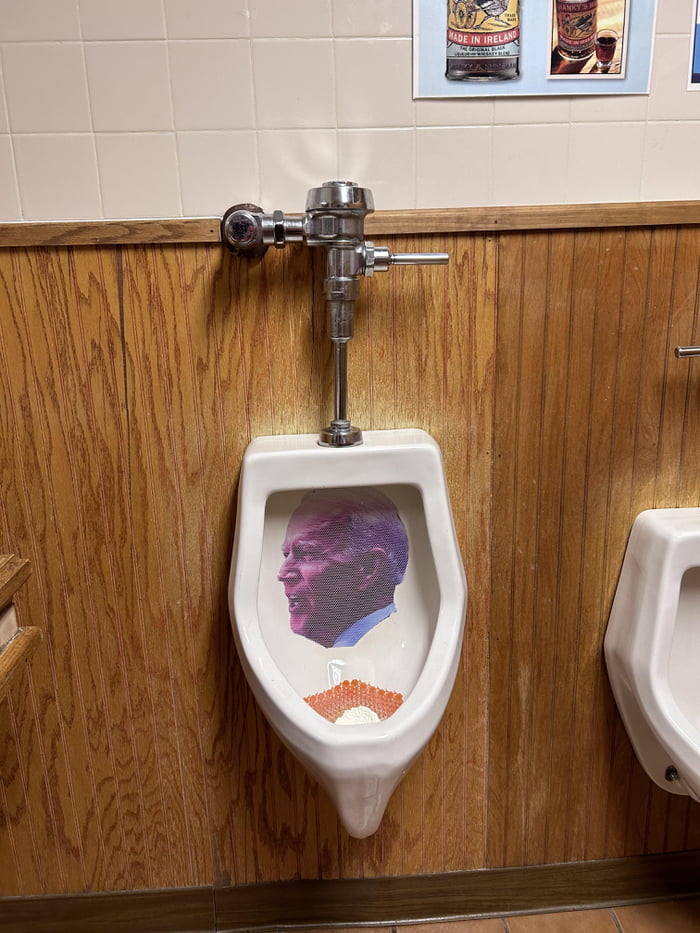 Joe Biden Sticker On a UrinalIn a Bar and Grill Image