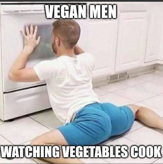 Vegan man watching vegetables cook