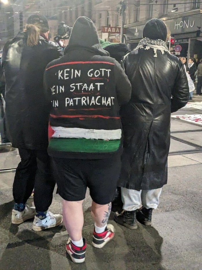 "No God, No State, No Patriarchy" - wears the flag of a STAT