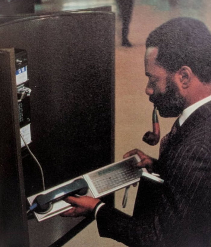 Traveling CEO checks his email, early 1980s.