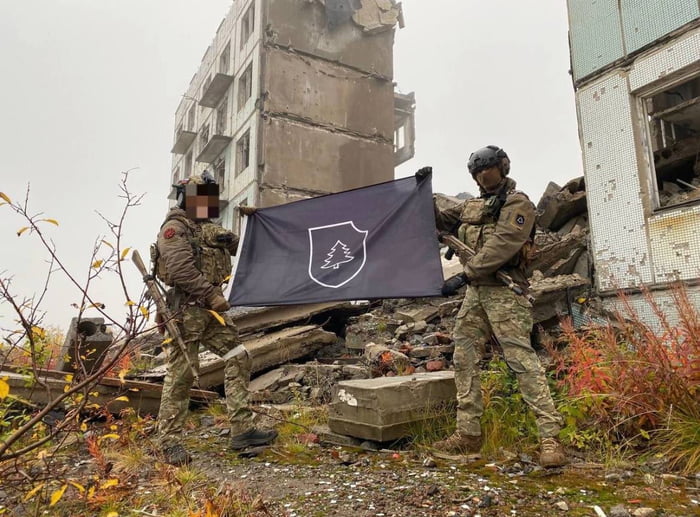 Based RuSSofascists with a Waffen-SS style flag in Marinka, 